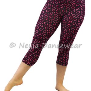 Mujer con leggins pirata Satiah estampados con círculos fucsia sobre fondo negro para danza.